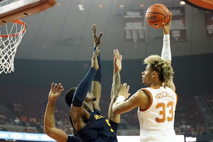 Jan 1, 2022; Austin, Texas, USA; Texas Longhorns forward Tre Mitchell (33) shoots over West Virginia Mountaineers forward Dimon Carrigan (5) during the first half at Frank C. Erwin Jr. Center.