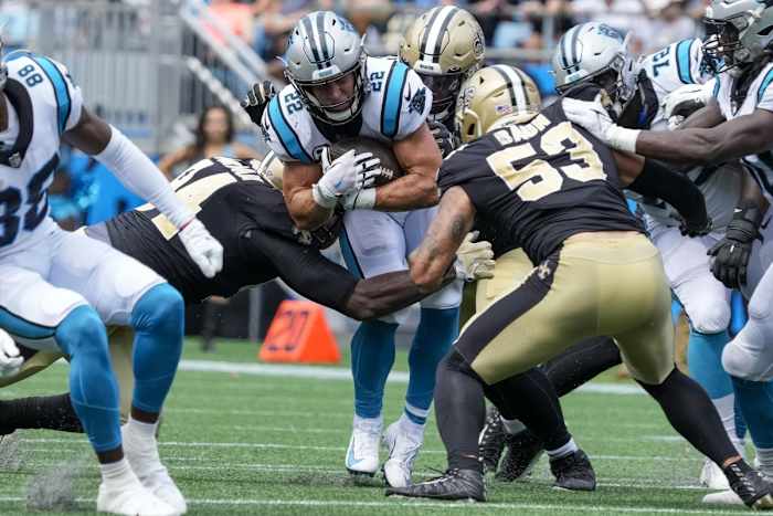 Carolina Panthers running back Christian McCaffrey (22) is tackled by the New Orleans Saints defense. Mandatory Credit: Jim Dedmon-USA TODAY Sports