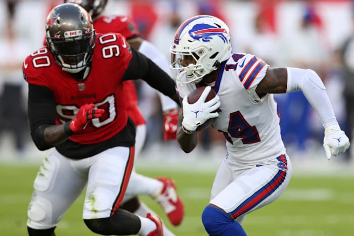 Buffalo Bills wide receiver Stefon Diggs (14) runs away from Tampa Bay Buccaneers linebacker Jason Pierre-Paul (90) after a catch during the first half of an NFL football game Sunday, Dec. 12, 2021, in Tampa, Fla.