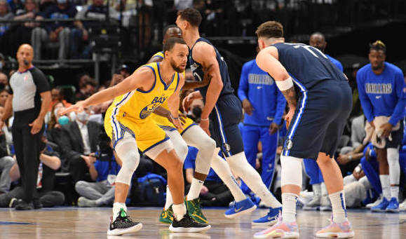 Steph Curry guarding Luka Doncic.