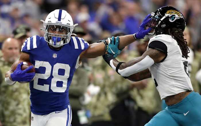 Indianapolis Colts running back Jonathan Taylor (28) still arms Jacksonville Jaguars free safety Rayshawn Jenkins (2) while rushing the ball Sunday, Nov. 14, 2021, during a game against the Jacksonville Jaguars at Lucas Oil Stadium in Indianapolis.