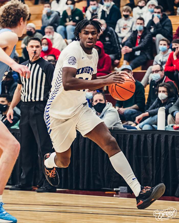 Mackenzie Mgbako holds a basketball in-game