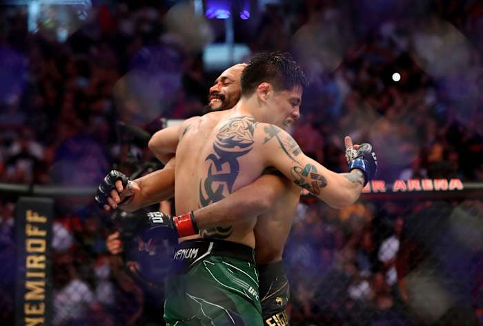 Brandon Moreno (l.) and Deiveson Figueiredo embrace after their fight at UFC 263 on June 12, 2021.