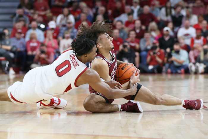 South Carolina Gamecocks guard Devin Carter (23) and Arkansas Razorbacks guard Stanley Umude (0) reach for a loose ball in the first half at Bud Walton Arena.