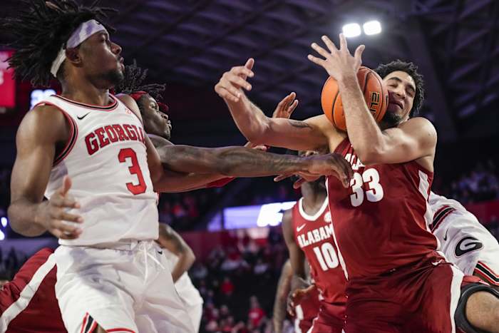 Alabama Crimson Tide forward James Rojas (33) tries to control the ball against Georgia Bulldogs guard Kario Oquendo (3) during the second half at Stegeman Coliseum.