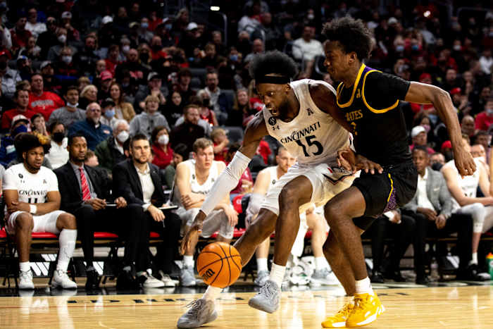 Cincinnati Bearcats forward John Newman III (15) drives on East Carolina Pirates guard Tristen Newton (2) in the second half of the NCAA men's basketball game on Wednesday, Jan. 12, 2022, at Fifth Third Arena in Cincinnati. Cincinnati Bearcats defeated East Carolina Pirates 79-71. East Carolina Pirates At Cincinnati Bearcats 120