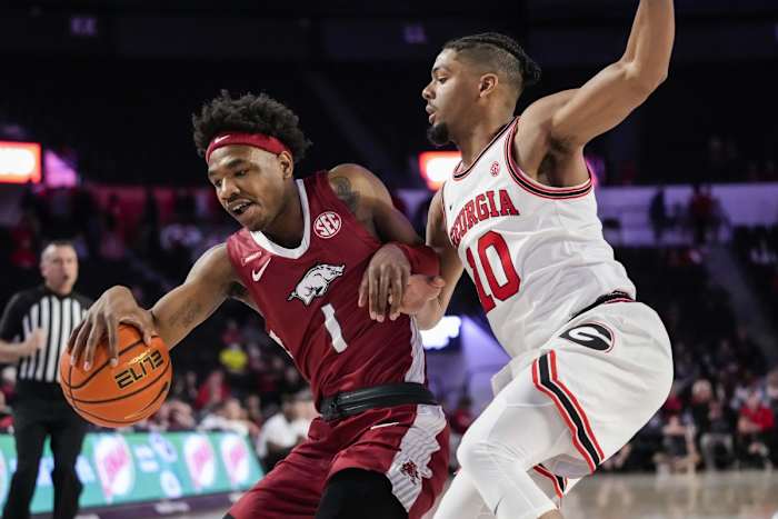 Arkansas Razorbacks guard JD Notae (1) dribbles against Georgia Bulldogs guard Aaron Cook (10) during the first half at Stegeman Coliseum.