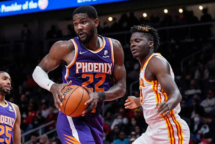 Deandre Ayton controls a rebound over Clint Capela.