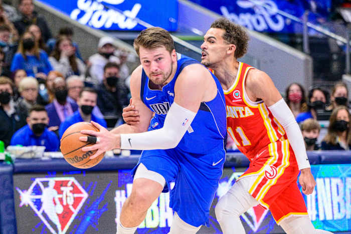 Hawks guard Trae Young defends Mavericks guard Luka Doncic.