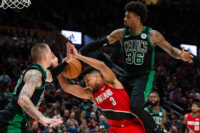 Feb 25, 2020; Portland, Oregon, USA; Portland Trail Blazers guard CJ McCollum (3) is fouled during the second half by Boston Celtics guard Marcus Smart (36) at Moda Center.