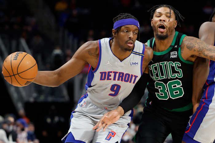 Feb 4, 2022; Detroit, Michigan, USA; Detroit Pistons forward Jerami Grant (9) dribbles defended by Boston Celtics guard Marcus Smart (36) in the first half at Little Caesars Arena.