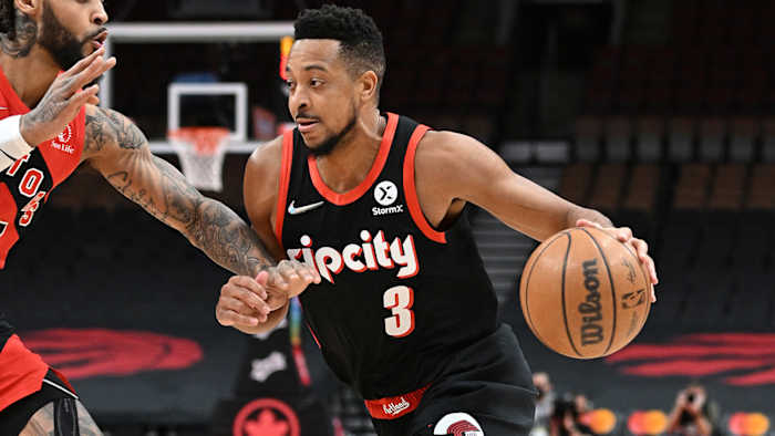 Portland Trail Blazers guard CJ McCollum (3) dribbles the ball past Toronto Raptors guard Gary Trent Jr.