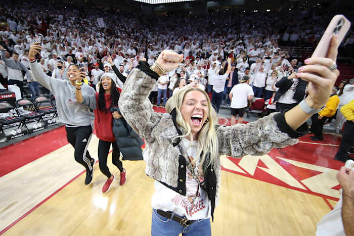 An Arkansas student rushes the court after the Razorbacks upset Auburn at Bud Walton Arena.