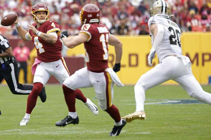 Washington quarterback Taylor Heinicke (4) passes under pressure from Saints linebacker Pete Werner (20). Mandatory Credit: Geoff Burke-USA TODAY Sports