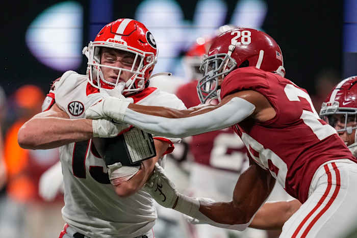Georgia Bulldogs tight end Brock Bowers (19) catches a pass in front of Alabama Crimson Tide defensive back Josh Jobe (28) before scoring a touchdown during the second half at Mercedes-Benz Stadium.