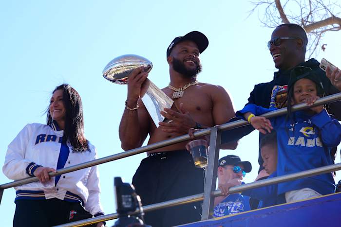Feb 16, 2022; Los Angeles, CA, USA; Los Angeles Rams defensive end Aaron Donald holds the Vince Lombardi trophy during Super Bowl LVI championship parade. Mandatory Credit: Kirby Lee-USA TODAY Sports