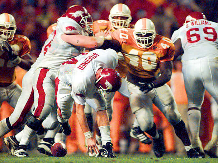 Arkansas' Clint Stoerner fumbles the ball in the closing minutes of play against Tennessee on Nov. 14, 1998, turning the ball over in Knoxville. The Vols' Billy Ratliff (40) recovered and Tennessee won the game 28-24. The play preserved Tennessee's undefeated season and they went on to win the national championship.