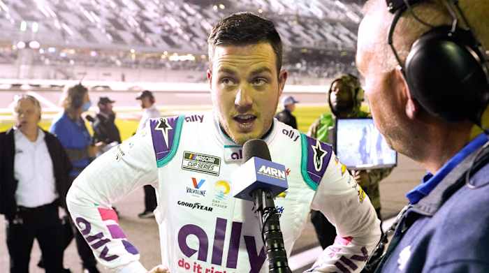 Alex Bowman talks with a reporter after he qualified second for the NASCAR Daytona 500 auto race at Daytona International Speedway, Wednesday, Feb. 16, 2022, in Daytona Beach, Fla.