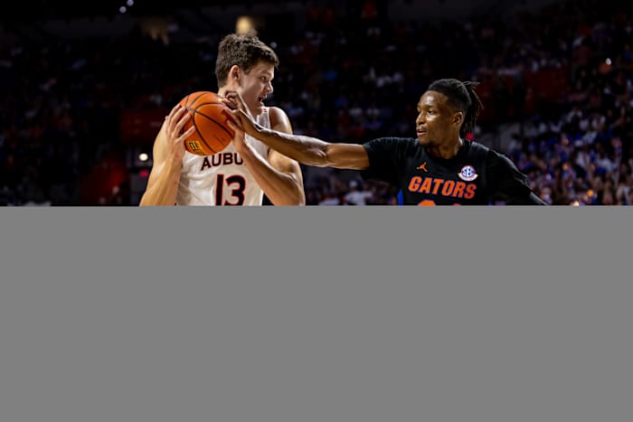 Feb 19, 2022; Gainesville, Florida, USA; Florida Gators guard Phlandrous Fleming Jr. (24) plays defense on Auburn Tigers forward Walker Kessler (13) during the first half at Billy Donovan Court at Exactech Arena. Mandatory Credit: Matt Pendleton-USA TODAY Sports