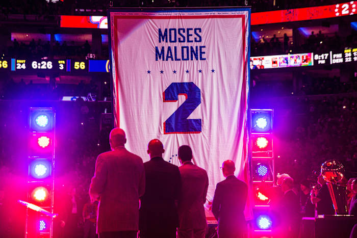 Feb 8, 2019; Philadelphia, PA, USA; Philadelphia 76ers great Julius Erving (L) and special guest look on as former 76ers great Moses Malone retired number banner is raised in the halftime ceremony in a game against the Denver Nuggets at Wells Fargo Center.