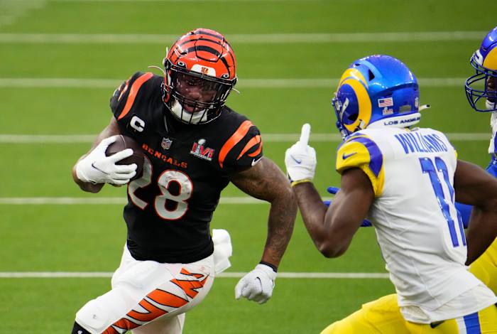 Feb 13, 2022; Inglewood, CA, USA; Cincinnati Bengals running back Joe Mixon (28) runs the ball against Los Angeles Rams cornerback Darious Williams (11) during the second quarter in Super Bowl LVI at SoFi Stadium. Mandatory Credit: Robert Hanashiro-USA TODAY Sports