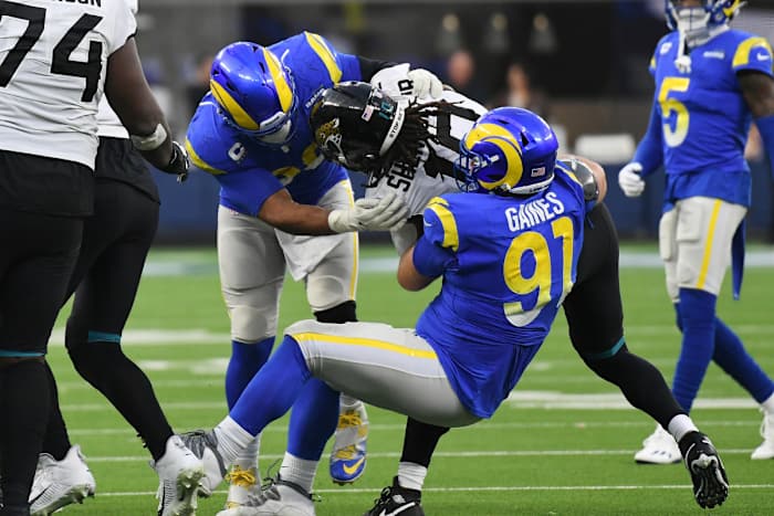 Dec 5, 2021; Inglewood, California, USA; Los Angeles Rams defensive end Aaron Donald (99) and defensive end Greg Gaines (91) tackle Jacksonville Jaguars wide receiver Laviska Shenault Jr. (10) in the fourth quarter at SoFi Stadium. Mandatory Credit: Richard Mackson-USA TODAY Sports