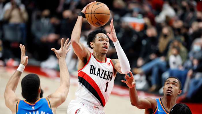 Portland Trail Blazers shooting guard Anfernee Simons (1) drives for the basket between Oklahoma City Thunder small forward Kenrich Williams.