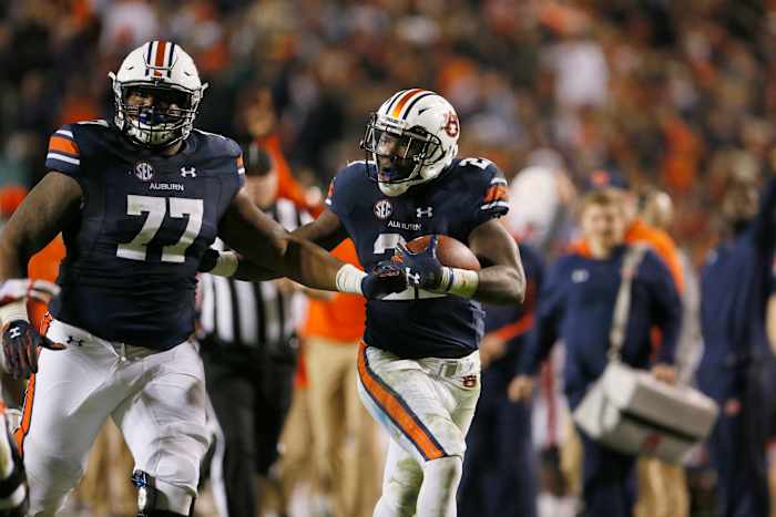 Nov 11, 2017; Auburn, AL, USA; Auburn Tigers running bak Kerryon Johnson (21) runs behind the block of lineman Marquel Harrell (77) and scores a touchdown against the Georgia Bulldogs during the fourth quarter at Jordan-Hare Stadium. Mandatory Credit: John Reed-USA TODAY Sports
