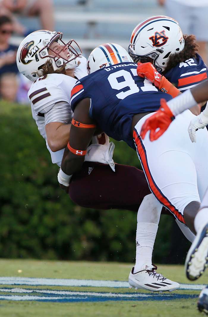 Oct 1, 2016; Auburn, AL, USA; Auburn Tigers lineman Andrew Williams (79) and linebacker Tre' Threat (42) tackle UL-Monroe Warhawks quarterback Garrett Smith (13) in the end zone for a safety during the fourth quarter at Jordan Hare Stadium. The Tigers beat the Warhawks 58-7. Mandatory Credit: John Reed-USA TODAY Sports