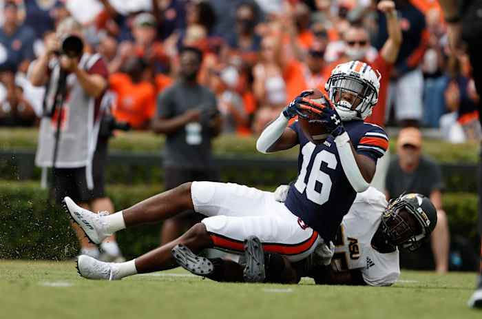 Sep 11, 2021; Auburn, Alabama, USA; Auburn Tigers wide receiver Malcolm Johnson Jr. (16) scores a touchdown as Alabama State Hornets defensive back Rodney Echols (25) defends during the third quarter at Jordan-Hare Stadium. Mandatory Credit: John Reed-USA TODAY Sports