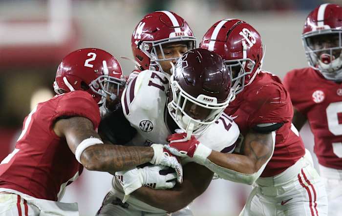 Alabama defensive back Patrick Surtain II (2), Alabama defensive back Brian Branch (14) and Alabama defensive back Malachi Moore (13) combine to tackle Mississippi State running back Jo'quavious Marks (21) at Bryant-Denny Stadium during the second half of Alabama's 41-0 win over Mississippi State.