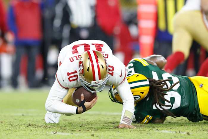 Jan 22, 2022; Green Bay, Wisconsin, USA; San Francisco 49ers quarterback Jimmy Garoppolo (10) is sacked by Green Bay Packers outside linebacker Za'Darius Smith (55) in the first quarter during a NFC Divisional playoff football game at Lambeau Field. Mandatory Credit: Jeff Hanisch-USA TODAY Sports