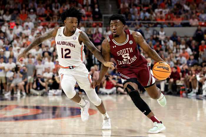 South Carolina guard Jermaine Couisnard (5) dribbles around Auburn guard Zep Jasper (12) as he goes to the basket during the first half of an NCAA college basketball game Saturday, March 5, 2022, in Auburn, Ala. (AP Photo/Butch Dill)