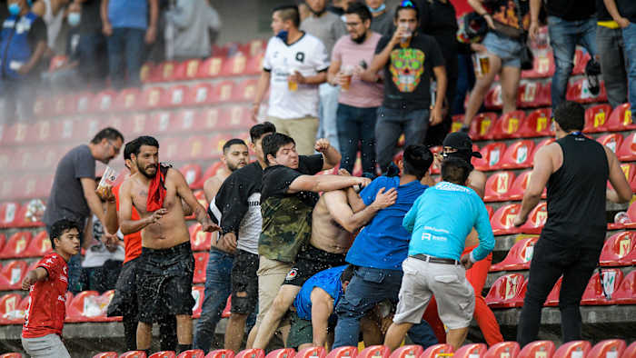 Fans of Queretaro and Atlas in Liga MX brawled in the stands and on the field