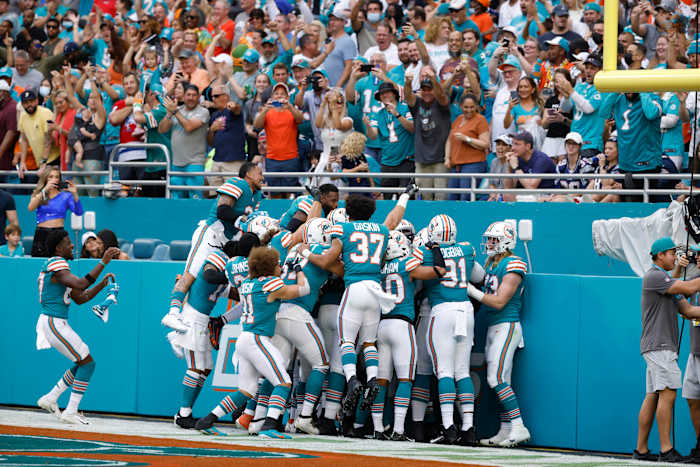 Jan 9, 2022; Miami Gardens, Florida, USA; The Miami Dolphins celebrate after cornerback Xavien Howard (25) scored a touchdown after intercepting the ball against the New England Patriots during the first quarter at Hard Rock Stadium. Mandatory Credit: Rhona Wise-USA TODAY Sports