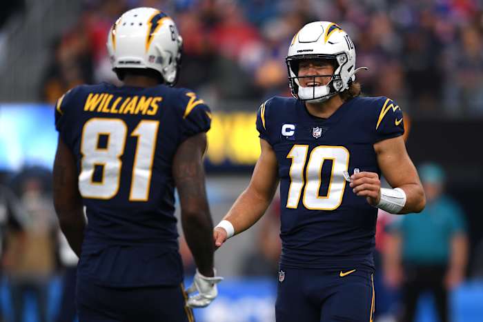 Oct 31, 2021; Inglewood, California, USA; Los Angeles Chargers quarterback Justin Herbert (10) talks to wide receiver Mike Williams (81) during the second half at SoFi Stadium. Mandatory Credit: Orlando Ramirez-USA TODAY Sports