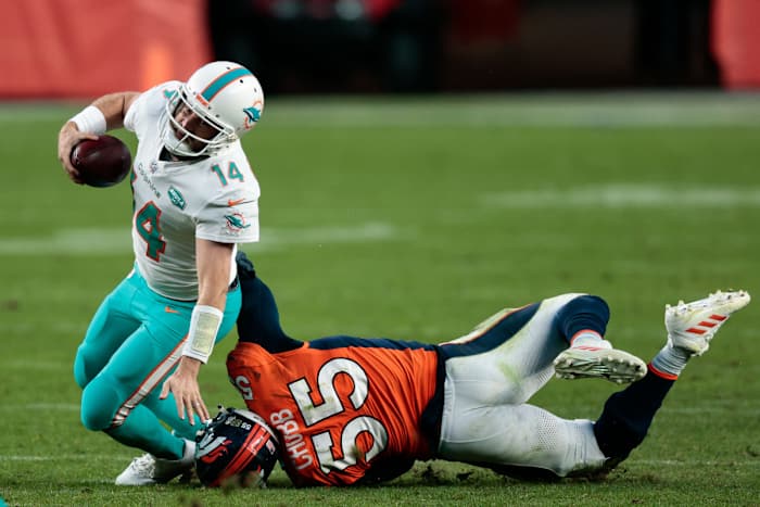 Nov 22, 2020; Denver, Colorado, USA; Miami Dolphins quarterback Ryan Fitzpatrick (14) is tackled by Denver Broncos outside linebacker Bradley Chubb (55) in the fourth quarter at Empower Field at Mile High. Mandatory Credit: Isaiah J. Downing-USA TODAY Sports