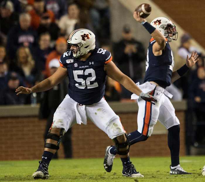 Auburn offensive lineman Nick Brahms (52) protects quarterback Bo Nix (10) as he throws the ball at Jordan-Hare Stadium in Auburn, Ala., on Saturday, Nov. 2, 2019. Auburn defeated Ole Miss 20-14.