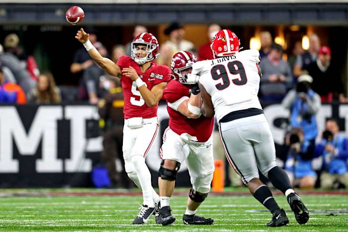 Jan 10, 2022; Indianapolis, IN, USA; Alabama Crimson Tide quarterback Bryce Young (9) throws a pass during the fourth quarter against Georgia Bulldogs defensive lineman Jordan Davis (99) in the 2022 CFP college football national championship game at Lucas Oil Stadium. Mandatory Credit: Mark J. Rebilas-USA TODAY Sports
