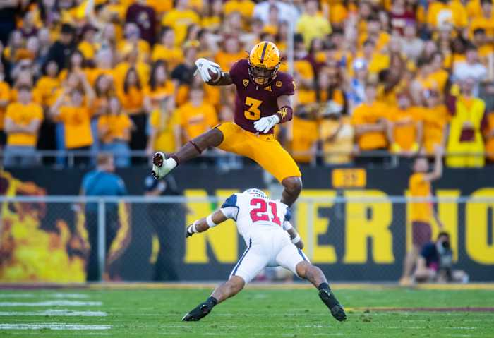 Nov 27, 2021; Tempe, Arizona, USA; Arizona State Sun Devils running back Rachaad White (3) jumps over Arizona Wildcats safety Jaxen Turner (21) during the second half at Sun Devil Stadium. Mandatory Credit: Mark J. Rebilas-USA TODAY Sports