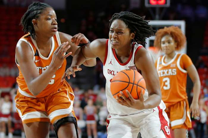 Oklahoma Sooners guard Madi Williams (25) goes past Texas Longhorns forward DeYona Gaston (5) during a women's college basketball game between the University of Oklahoma Sooners (OU) and the Texas Longhorns at Lloyd Noble in Norman, Saturday, Jan. 29, 2022. Oklahoma won 65-63. Ou Women Vs Texas