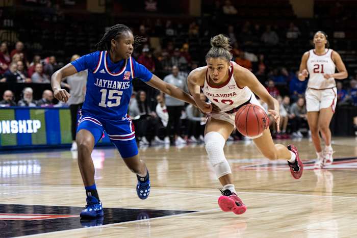 Mar 11, 2022; Kansas City, MO, USA; Oklahoma Sooners guard Kelbie Washington (10) handles the ball while defended by Kansas Jayhawks guard Zakiyah Franklin (15) in the first half at Municipal Auditorium. Mandatory Credit: Amy Kontras-USA TODAY Sports