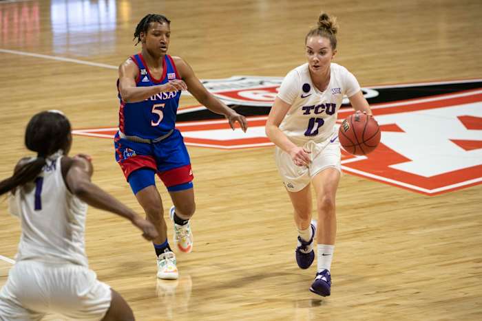 Mar 11, 2021; MO, Kansas City, USA; Kansas Jayhawks guard Aniya Thomas (5) defends against TCU Horned Frogs guard Caroline Germond (0) in the first half at Municipal Auditorium. Mandatory Credit: Amy Kontras-USA TODAY Sports