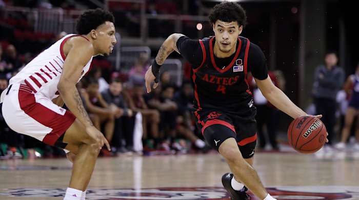 San Diego State's Trey Pulliam, right, drives past a Fresno State's defender during the first half of an NCAA college basketball game in Fresno, Calif., Saturday, Feb. 19, 2022.
