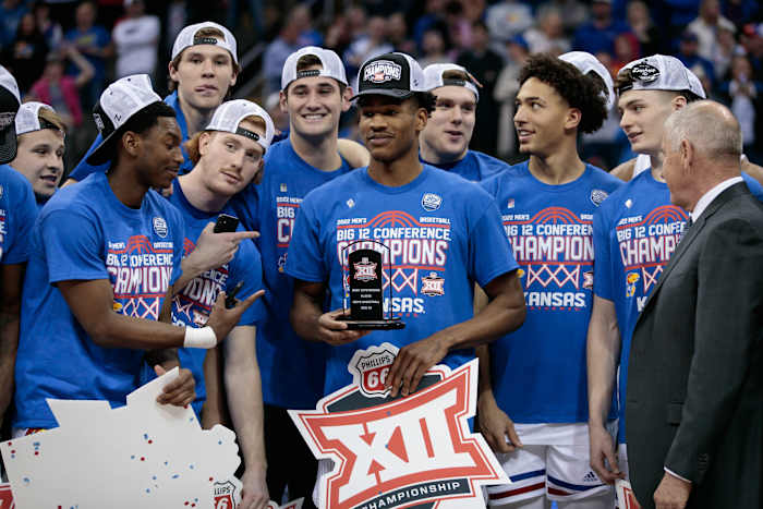 Mar 12, 2022; Kansas City, MO, USA; Kansas Jayhawks guard Ochai Agbaji (30) is presented the most outstanding player award after the game against the Texas Tech Red Raiders at T-Mobile Center. Mandatory Credit: William Purnell-USA TODAY Sports