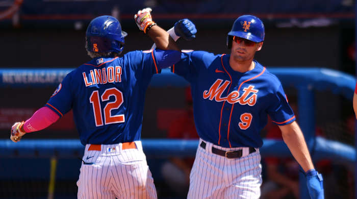 Port St. Lucie, Florida, USA; New York Mets shortstop Francisco Lindor (12) is greeted by teammate Brandon Nimmo (9) after hitting a grand slam in the fourth inning during a spring training game in 2021 at Clover Park.