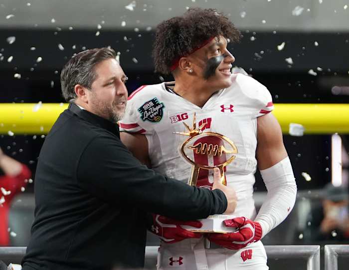 Wisconsin running back Braelon Allen holding the Las Vegas Bowl MVP trophy.