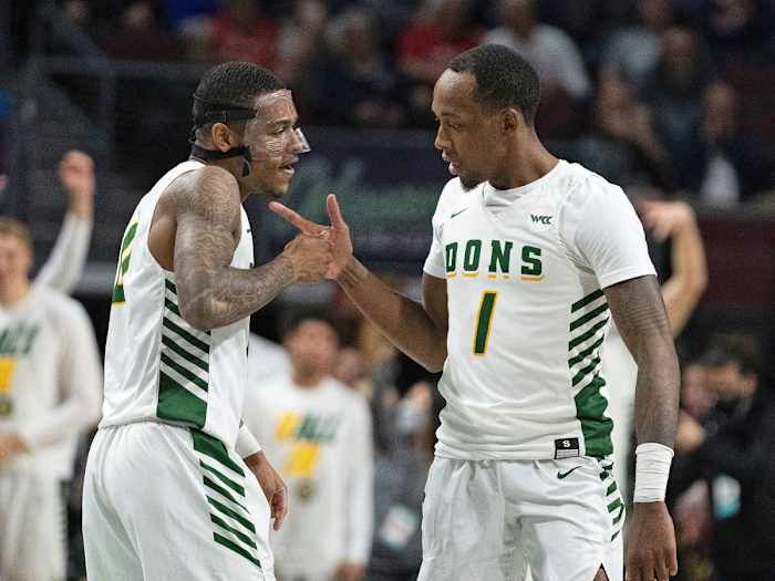 San Francisco’s Jamaree Bouyea (1) celebrates with guard Khalil Shabazz