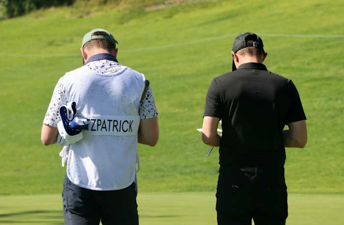 Matt Fitzpatrick (right) and his caddy stand on the 18th hole of the Riviera Country Club, finishing up the golfer's participation in the Genesis Invitational Collegiate Showcase.