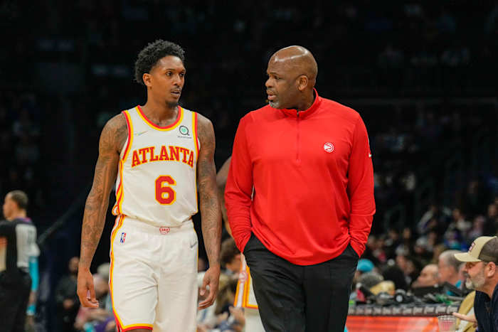 Mar 16, 2022; Charlotte, North Carolina, USA; Atlanta Hawks head coach Nate McMillan head coach Nate McMillan talks with guard Lou Williams (6) during the second quarter against the Charlotte Hornets at the Spectrum Center.